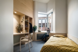 Mental health bedroom with a secure window providing natural light, illustrating the type of environment supported by effective secure window maintenance.